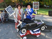 Lynn from Paramus and Kathy from Woodridge, N.J., with their dog Avery Finn, pose for a photo during the Washington Square Park Halloween Do...