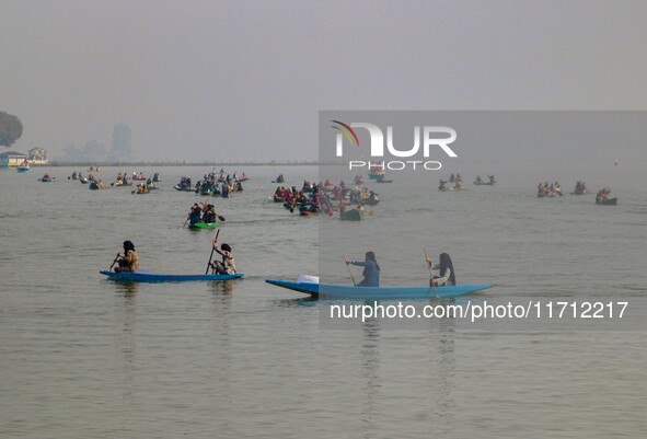 Kashmiri women row boats during the traditional women's boat race at Dal Lake in Srinagar, Jammu and Kashmir, on October 27, 2024. The Jammu...