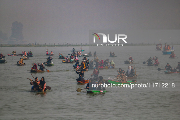 Kashmiri women row boats during the traditional women's boat race at Dal Lake in Srinagar, Jammu and Kashmir, on October 27, 2024. The Jammu...