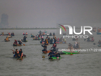 Kashmiri women row boats during the traditional women's boat race at Dal Lake in Srinagar, Jammu and Kashmir, on October 27, 2024. The Jammu...