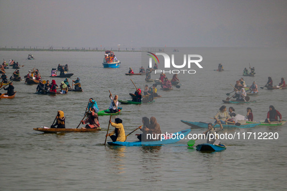 Kashmiri women row boats during the traditional women's boat race at Dal Lake in Srinagar, Jammu and Kashmir, on October 27, 2024. The Jammu...