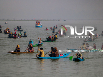 Kashmiri women row boats during the traditional women's boat race at Dal Lake in Srinagar, Jammu and Kashmir, on October 27, 2024. The Jammu...