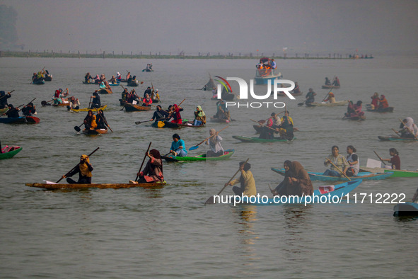 Kashmiri women row boats during the traditional women's boat race at Dal Lake in Srinagar, Jammu and Kashmir, on October 27, 2024. The Jammu...