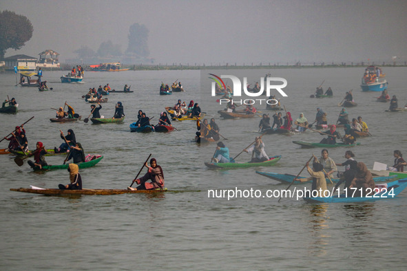 Kashmiri women row boats during the traditional women's boat race at Dal Lake in Srinagar, Jammu and Kashmir, on October 27, 2024. The Jammu...