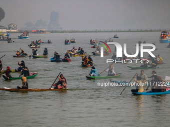 Kashmiri women row boats during the traditional women's boat race at Dal Lake in Srinagar, Jammu and Kashmir, on October 27, 2024. The Jammu...