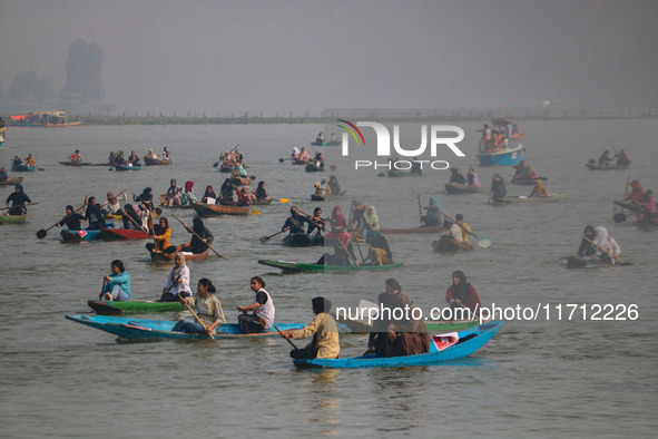 Kashmiri women row boats during the traditional women's boat race at Dal Lake in Srinagar, Jammu and Kashmir, on October 27, 2024. The Jammu...