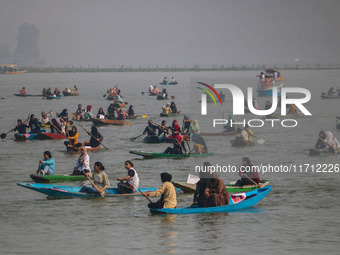 Kashmiri women row boats during the traditional women's boat race at Dal Lake in Srinagar, Jammu and Kashmir, on October 27, 2024. The Jammu...