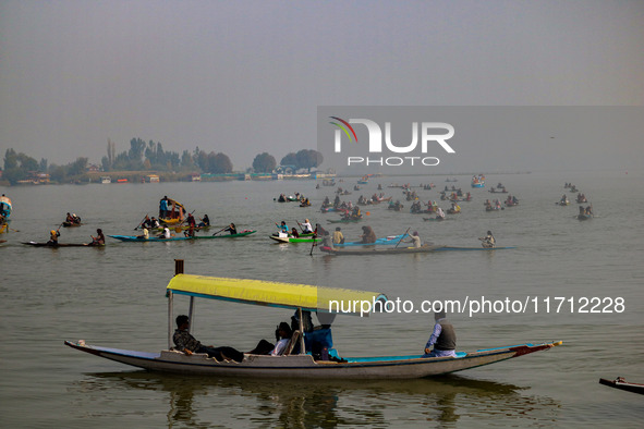 Kashmiri women row boats during the traditional women's boat race at Dal Lake in Srinagar, Jammu and Kashmir, on October 27, 2024. The Jammu...