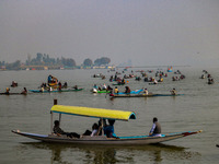 Kashmiri women row boats during the traditional women's boat race at Dal Lake in Srinagar, Jammu and Kashmir, on October 27, 2024. The Jammu...