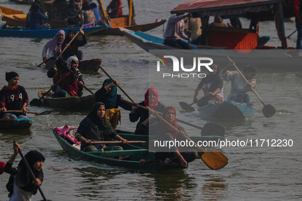 Kashmiri women row boats during the traditional women's boat race at Dal Lake in Srinagar, Jammu and Kashmir, on October 27, 2024. The Jammu...