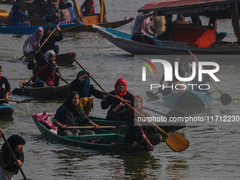 Kashmiri women row boats during the traditional women's boat race at Dal Lake in Srinagar, Jammu and Kashmir, on October 27, 2024. The Jammu...