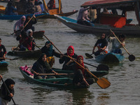 Kashmiri women row boats during the traditional women's boat race at Dal Lake in Srinagar, Jammu and Kashmir, on October 27, 2024. The Jammu...