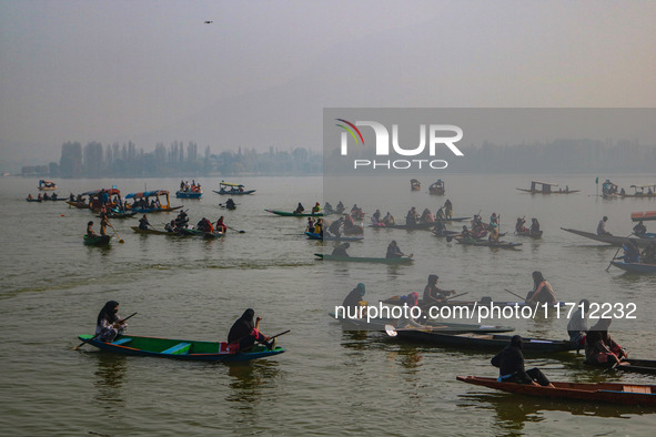 Kashmiri women row boats during the traditional women's boat race at Dal Lake in Srinagar, Jammu and Kashmir, on October 27, 2024. The Jammu...