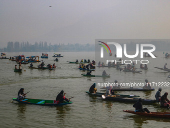 Kashmiri women row boats during the traditional women's boat race at Dal Lake in Srinagar, Jammu and Kashmir, on October 27, 2024. The Jammu...