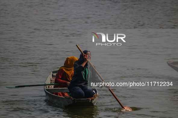 Kashmiri women row boats during the traditional women's boat race at Dal Lake in Srinagar, Jammu and Kashmir, on October 27, 2024. The Jammu...