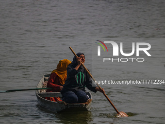 Kashmiri women row boats during the traditional women's boat race at Dal Lake in Srinagar, Jammu and Kashmir, on October 27, 2024. The Jammu...