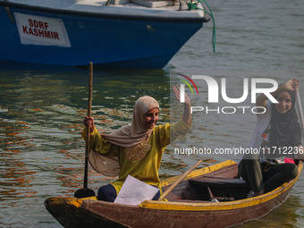 Kashmiri girls react during the traditional women's boat race at Dal Lake in Srinagar, Jammu and Kashmir, on October 27, 2024. The Jammu and...