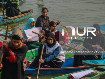 Kashmiri women row boats during the traditional women's boat race at Dal Lake in Srinagar, Jammu and Kashmir, on October 27, 2024. The Jammu...