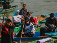 Kashmiri women row boats during the traditional women's boat race at Dal Lake in Srinagar, Jammu and Kashmir, on October 27, 2024. The Jammu...