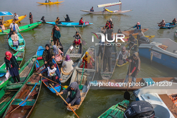 Kashmir girls react near the finish line during the traditional women's boat race in Srinagar, Jammu and Kashmir, on October 27, 2024. The J...