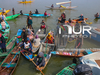 Kashmir girls react near the finish line during the traditional women's boat race in Srinagar, Jammu and Kashmir, on October 27, 2024. The J...