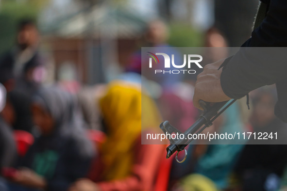 An Indian policeman stands guard during the traditional women's boat race in Srinagar, Jammu and Kashmir, on October 27, 2024. The Jammu and...