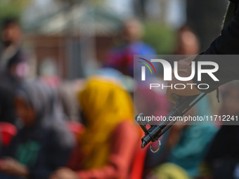 An Indian policeman stands guard during the traditional women's boat race in Srinagar, Jammu and Kashmir, on October 27, 2024. The Jammu and...