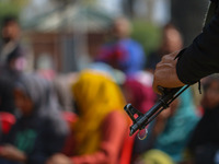 An Indian policeman stands guard during the traditional women's boat race in Srinagar, Jammu and Kashmir, on October 27, 2024. The Jammu and...