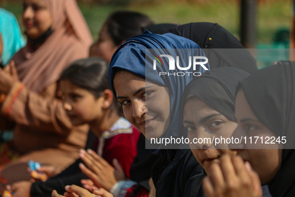 A girl looks on during the traditional women's boat race in Srinagar, Jammu and Kashmir, on October 27, 2024. The Jammu and Kashmir Water Sp...