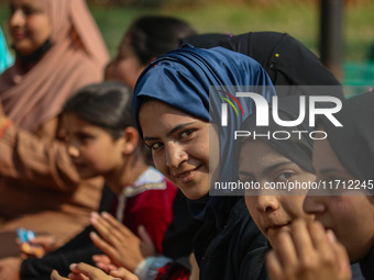 A girl looks on during the traditional women's boat race in Srinagar, Jammu and Kashmir, on October 27, 2024. The Jammu and Kashmir Water Sp...