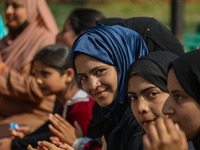 A girl looks on during the traditional women's boat race in Srinagar, Jammu and Kashmir, on October 27, 2024. The Jammu and Kashmir Water Sp...