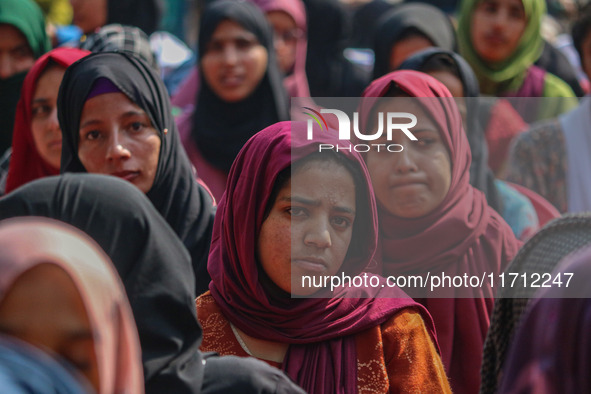 A girl looks on during the traditional women's boat race in Srinagar, Jammu and Kashmir, on October 27, 2024. The Jammu and Kashmir Water Sp...