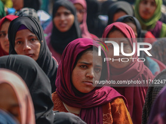 A girl looks on during the traditional women's boat race in Srinagar, Jammu and Kashmir, on October 27, 2024. The Jammu and Kashmir Water Sp...