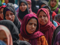 A girl looks on during the traditional women's boat race in Srinagar, Jammu and Kashmir, on October 27, 2024. The Jammu and Kashmir Water Sp...