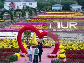 Tourists view chrysanthemums at the Chrysanthemum Garden at Jiangning Lake in Nanjing, China, on October 27, 2024. (