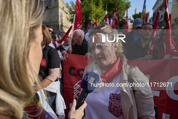 Gigia Bucci, General Secretary of CGIL Puglia, speaks at a rally advocating for world peace. Thousands of people march through Bari, Italy,...