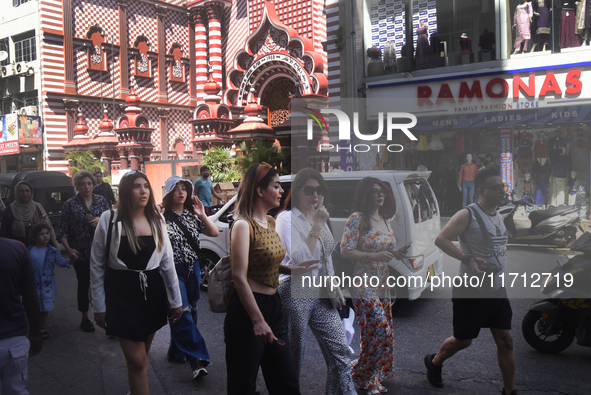 Tourists take pictures in front of the Red Mosque in Colombo, Sri Lanka, on October 26, 2024.   