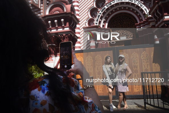 Tourists take pictures in front of the Red Mosque in Colombo, Sri Lanka, on October 26, 2024.   