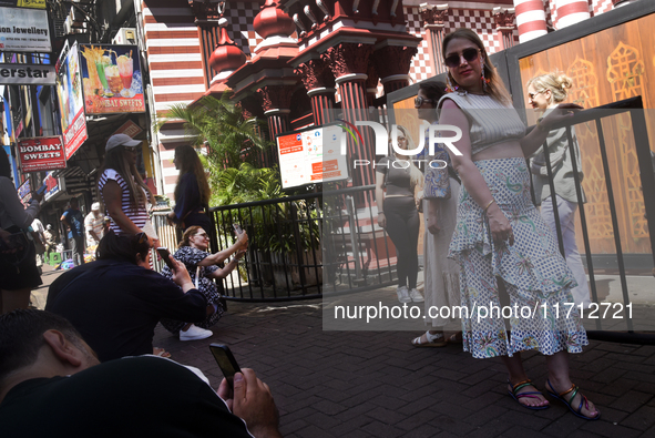 Tourists take pictures in front of the Red Mosque in Colombo, Sri Lanka, on October 26, 2024.   