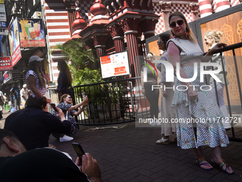 Tourists take pictures in front of the Red Mosque in Colombo, Sri Lanka, on October 26, 2024.   (