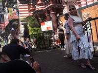 Tourists take pictures in front of the Red Mosque in Colombo, Sri Lanka, on October 26, 2024.   (