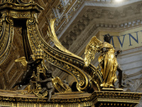 A picture shows a statue of the newly renovated baldachin, a large Baroque sculpted bronze canopy over the high altar of St. Peter's Basilic...