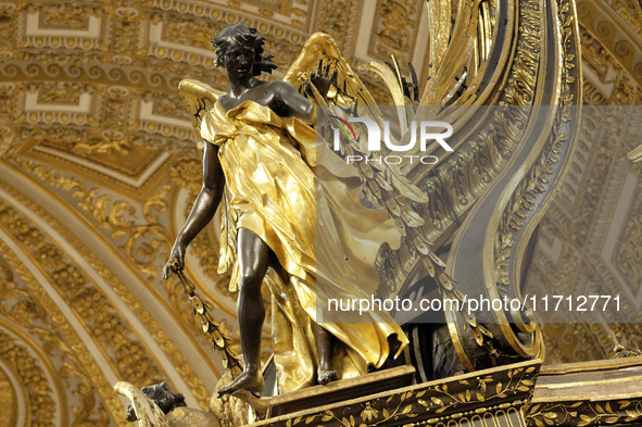 A picture shows a statue of the newly renovated baldachin, a large Baroque sculpted bronze canopy over the high altar of St. Peter's Basilic...