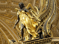 A picture shows a statue of the newly renovated baldachin, a large Baroque sculpted bronze canopy over the high altar of St. Peter's Basilic...