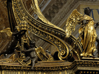 A picture shows a statue of the newly renovated baldachin, a large Baroque sculpted bronze canopy over the high altar of St. Peter's Basilic...