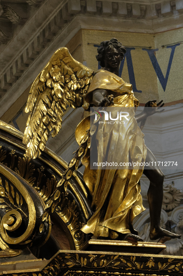 A picture shows a statue of the newly renovated baldachin, a large Baroque sculpted bronze canopy over the high altar of St. Peter's Basilic...