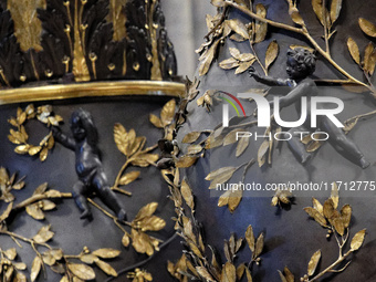 A picture shows a statue of the newly renovated baldachin, a large Baroque sculpted bronze canopy over the high altar of St. Peter's Basilic...