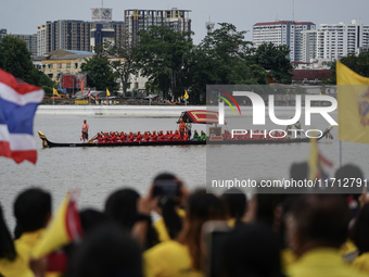 Thai oarsmen in traditional costume row during the Royal Barge Procession for the Royal Kathin ceremony along the Chao Phraya River in Bangk...