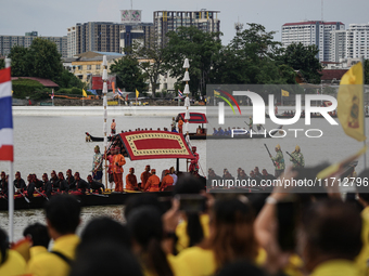 Thai oarsmen in traditional costume row during the Royal Barge Procession for the Royal Kathin ceremony along the Chao Phraya River in Bangk...