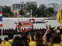 Thai oarsmen in traditional costume row during the Royal Barge Procession for the Royal Kathin ceremony along the Chao Phraya River in Bangk...